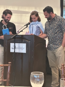 Photo of young girl at microphone announcing winners in the